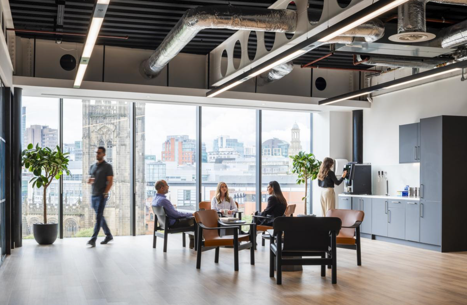 Corporate lounge and collaboration space with clean floors and tall windows.
